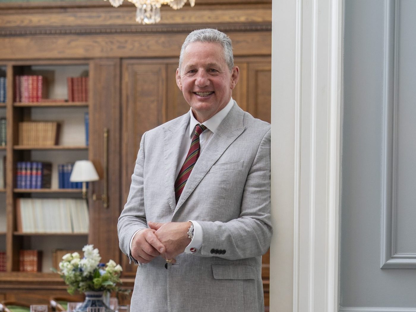 A headshot of Chairman of the Members Committee Guy Richardson, smiling and slightly leaning against a wall.